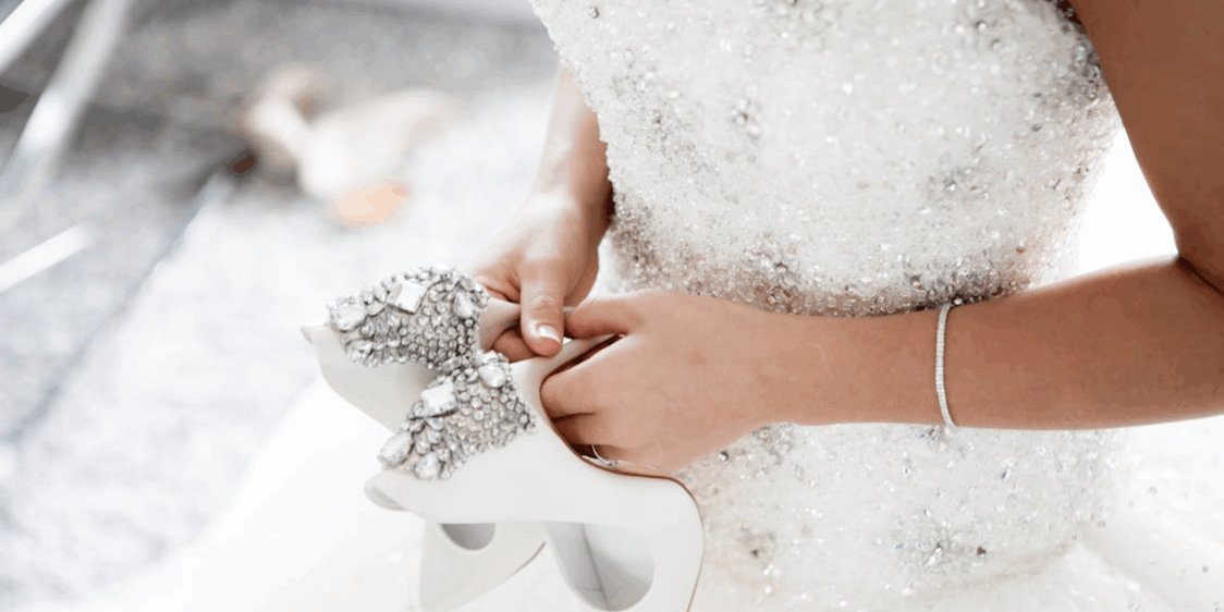 a woman holding her shoes